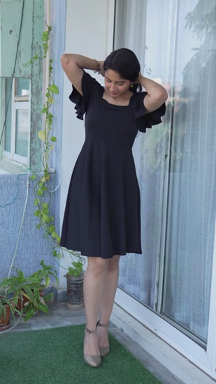 Modish Noir Square Neck Flare Dress: Elevate your style with this black A-line dress. It features a flattering square neck, half sleeves, and a flared silhouette. Crafted from polyester for comfort and style. Discover fashion at Wyshlist. 